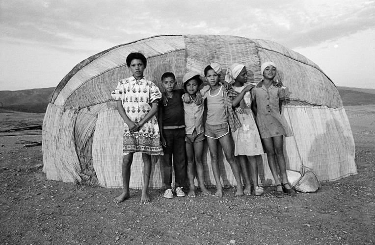 Photo of Children standing in front of Matjieshuis, Namaqualand, 1987
