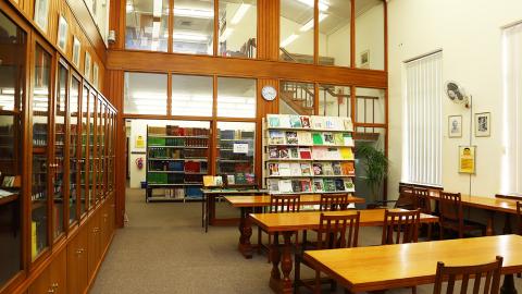 Long desks with chairs inside reading room of Bolus Library