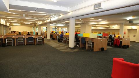 Students studying inside main reading room of Law Library