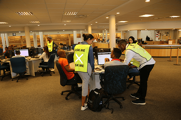 Student assistants assisting students in Chancellor Oppenheimer Library